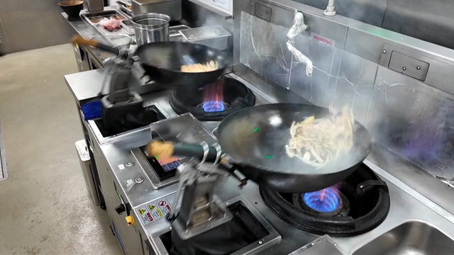 Robot stir-frying vegetables in the kitchen