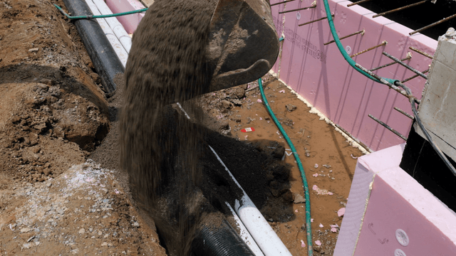 Construction site with excavator and pipes