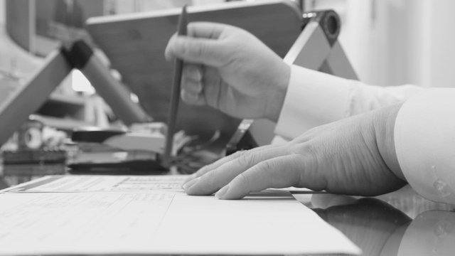 Person working at a desk with documents