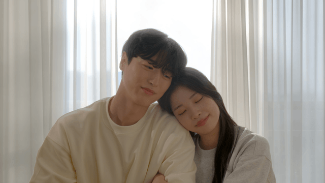 Couple resting together by cozy window