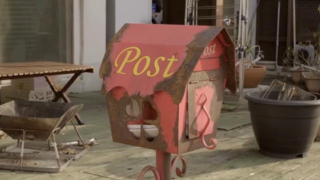 Rustic mailbox on a wooden deck