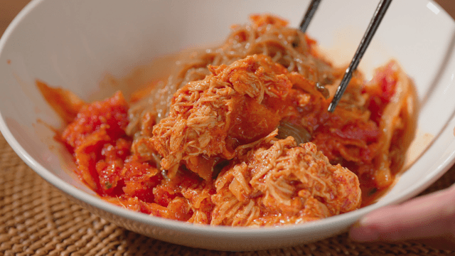 Spicy mixed noodles in a white bowl