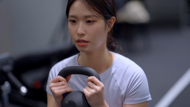 Young woman doing kettlebell squat exercise