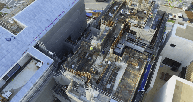 Construction site with workers and buildings