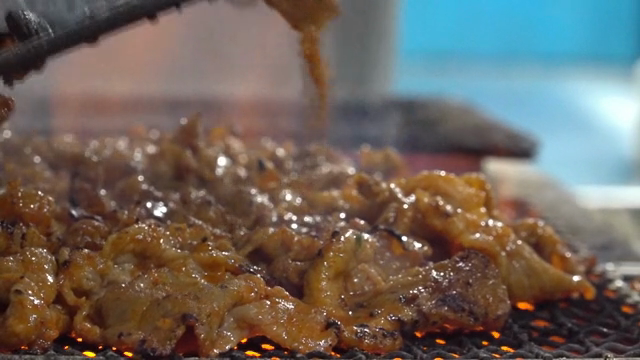 Grilled meat sizzling on a barbecue
