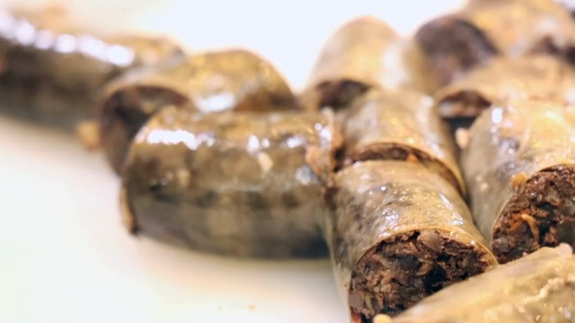 Korean sausage being sliced on a board