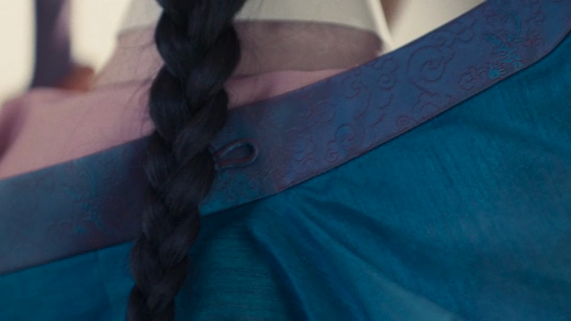 A girl wearing a hanbok and with braided hair