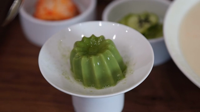 Green pudding in a white bowl