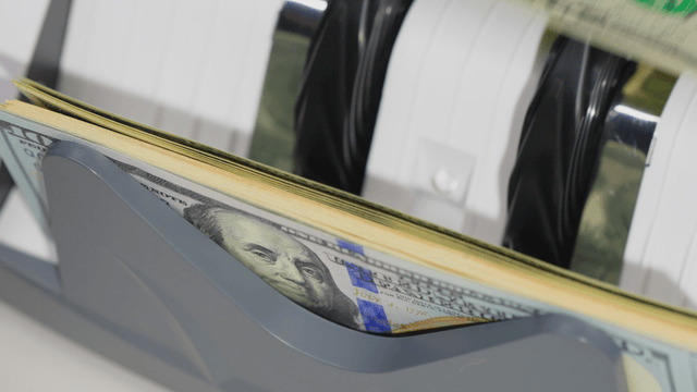 Counting machine processing dollar bills