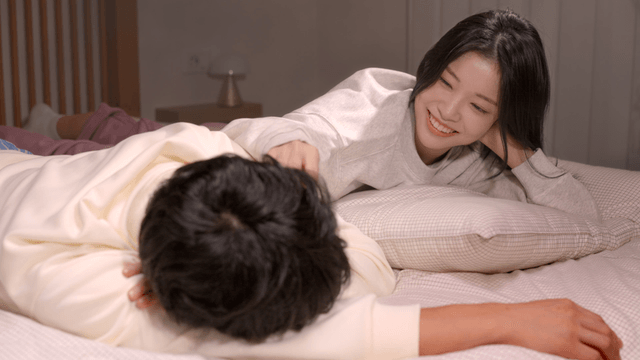 Couple resting together on bed