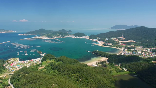 Coastal village with lush green hills