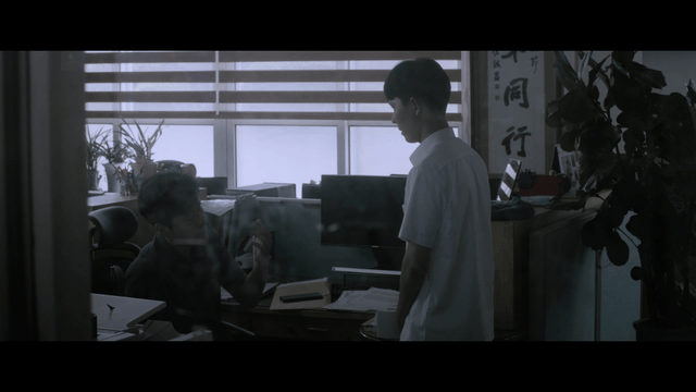 Serious student and teacher talking in dark teachers’ office