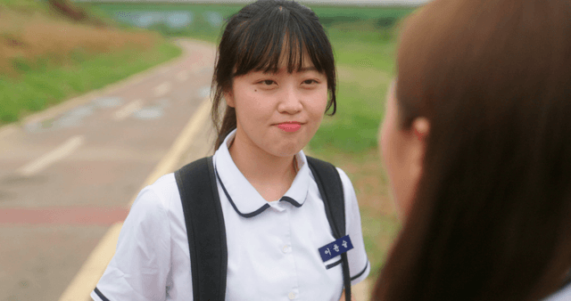 Two students having a conversation on a path