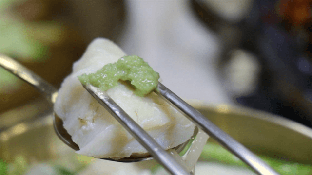 Spoon holding cod piece with wasabi