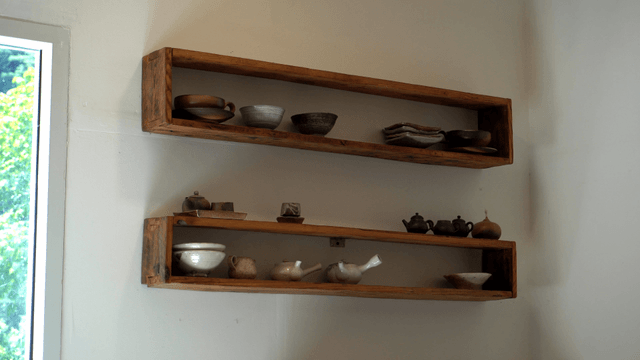 Wooden shelves with pottery and teapots