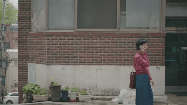 Woman talking on the phone outside a building
