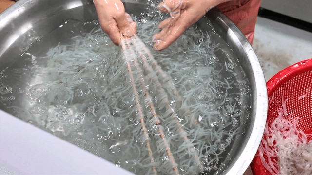 Rinsing ice fish in large metal basin