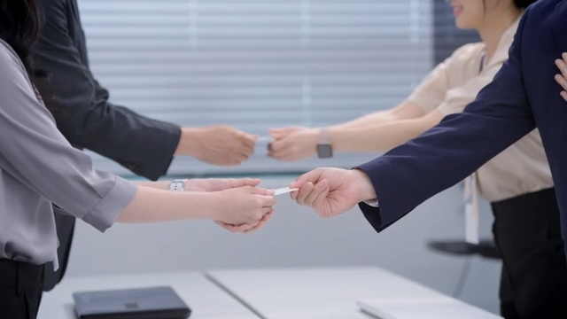 Business meeting with card exchange