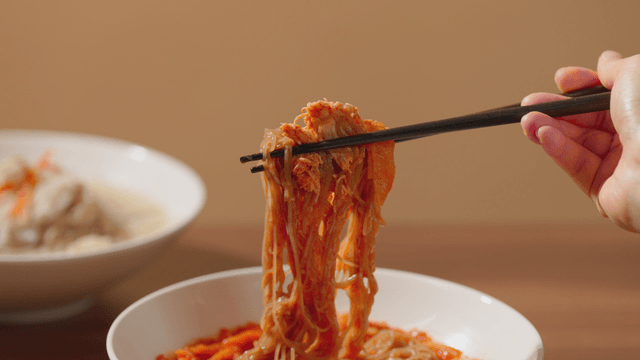 Chopsticks lifting spicy noodles