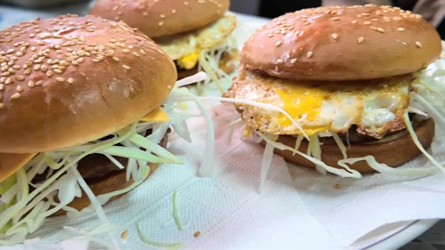 Three burgers with egg and cabbage