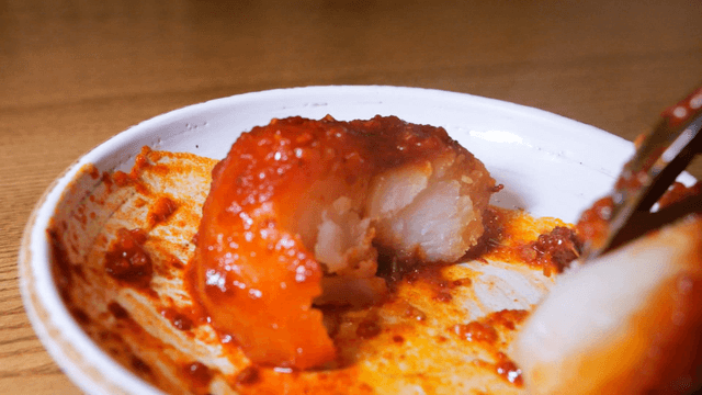 Soft potato from spicy braised chicken breaking easily on a spoon