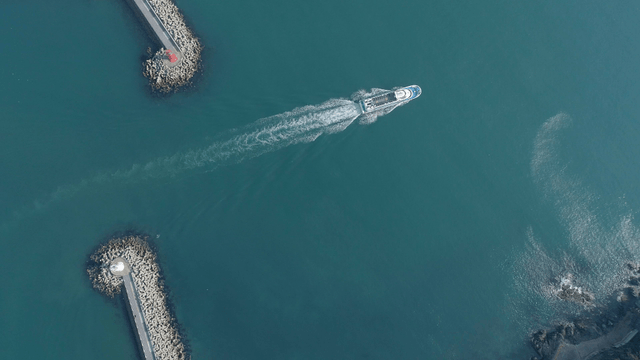 Ship navigating between breakwaters