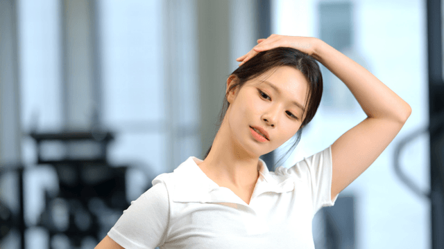 Woman stretching neck at gym