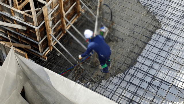Construction workers pouring concrete