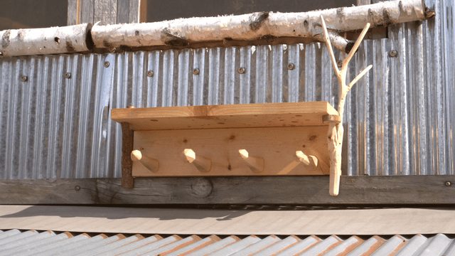 Wooden shelf on corrugated metal wall