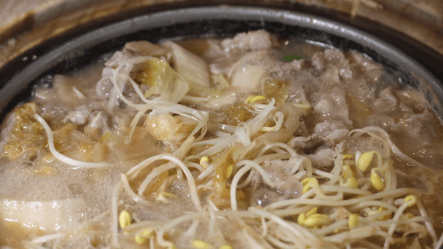 Boiling bean sprout and white ripened kimchi stew in pot