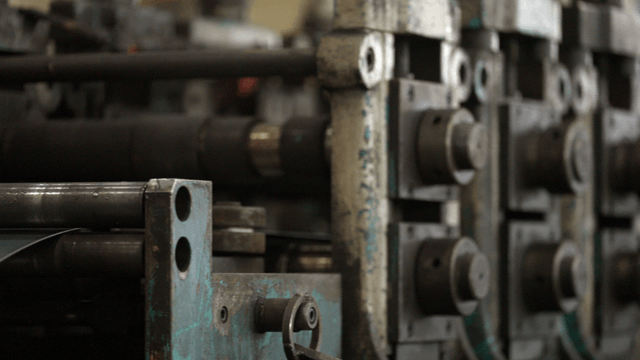 Metal sheets being processed in a factory