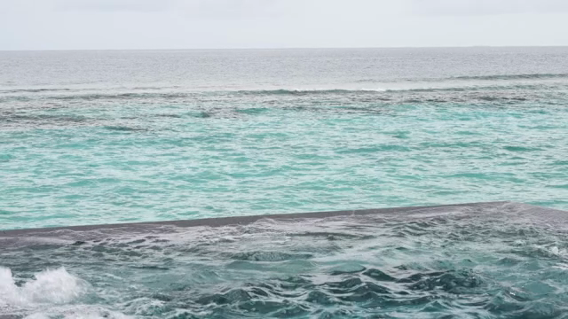Calm ocean waves under a cloudy sky