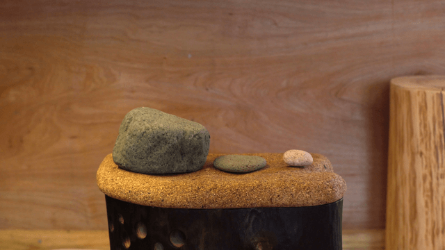 Various stones on a wooden chair with a cork top
