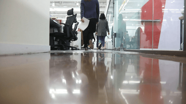 Office hallway with people walking