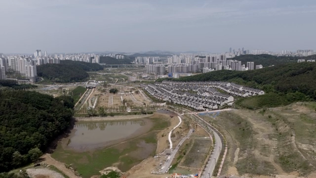 A sprawling cityscape with surrounding hills