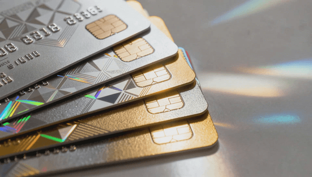 Pile of credit cards reflecting holographic light