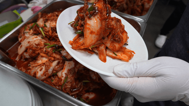 Red kimchi placed on white plate