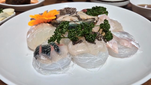 A plate of fresh sashimi with garnish