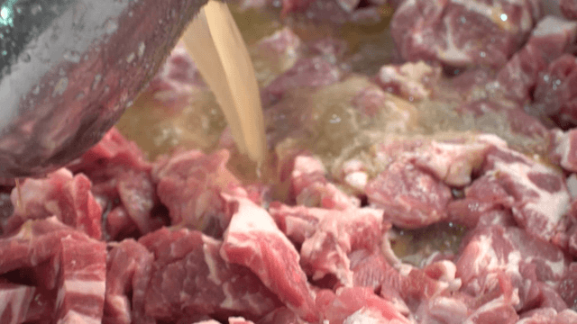 Marinade poured over raw pork ribs