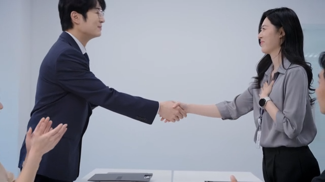 A meeting scene where the signed contract is handed over