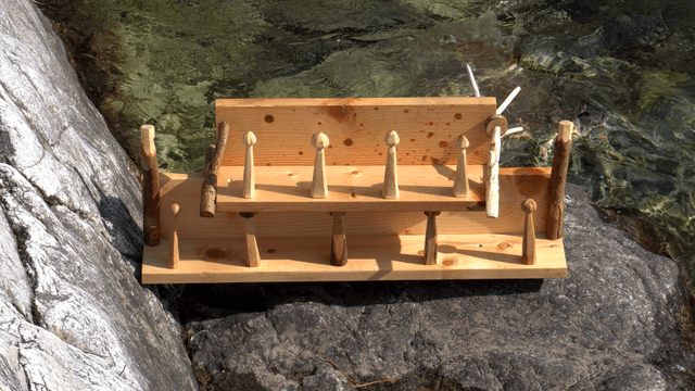 Wooden shelf beside a clear stream