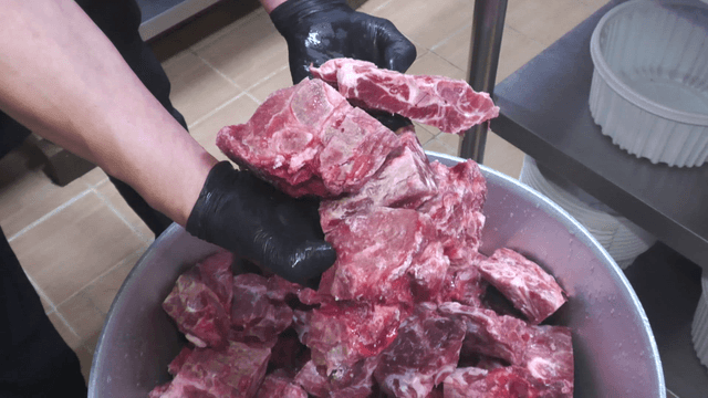 Raw meat placed in a large pot
