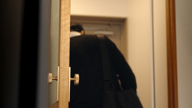 Couple stepping out from cozy home entrance