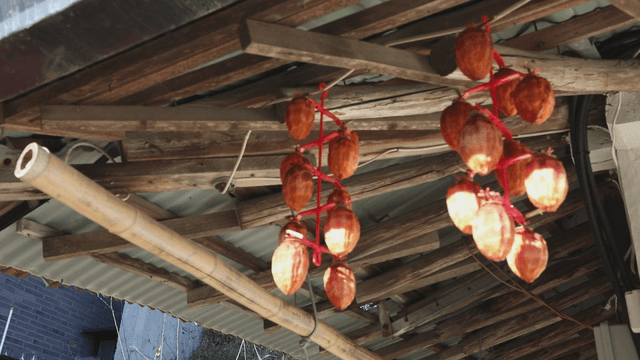Dried persimmons hanging under a roof