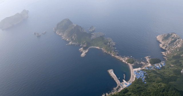 Aerial view of a misty island and coastline