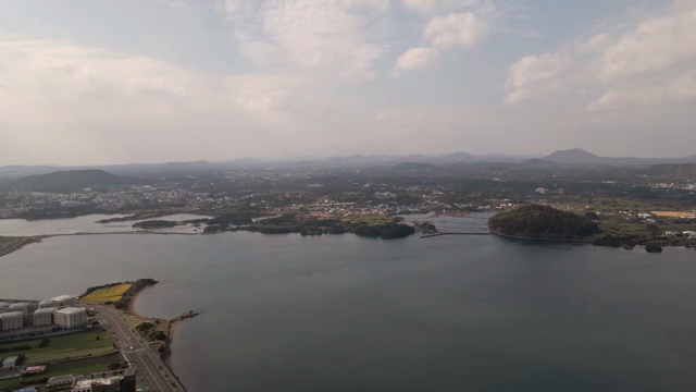 A coastal town with distant mountains