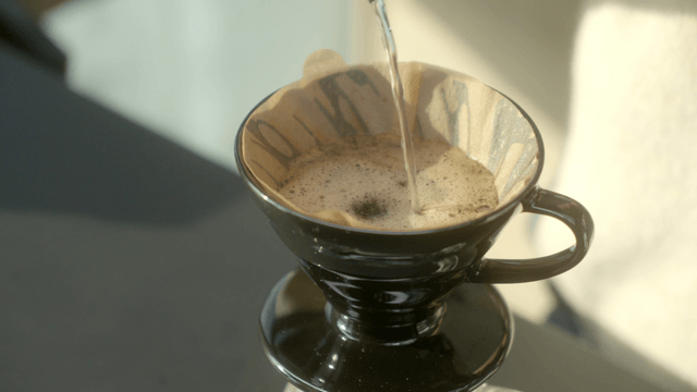 Hot water being poured into a coffee dripper