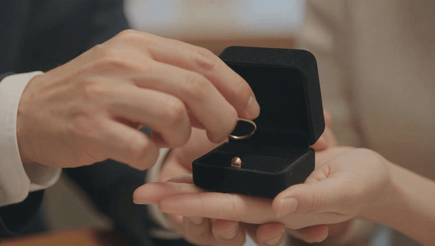 Couple taking ring from ring box