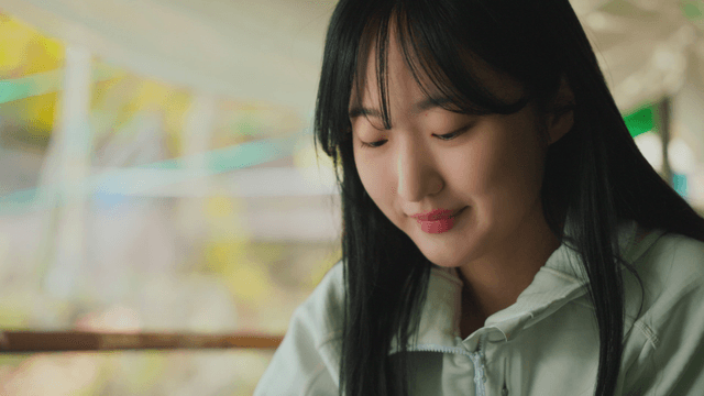 Young woman eating white chicken soup at forest mountain hut