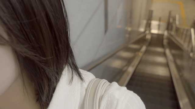 Woman riding an escalator